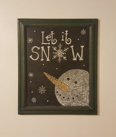 a chalkboard with the words let it snow written on it and an image of a polar bear