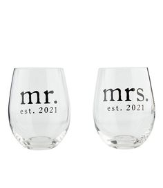 two wine glasses with the words mr and mrs printed on each one, sitting side by side