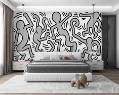 a modern bedroom with black and white artwork on the wall behind the bed, along with an elephant statue