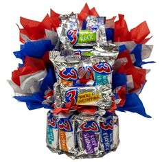 an arrangement of candy bars wrapped in red, white and blue paper streamers on top of each other