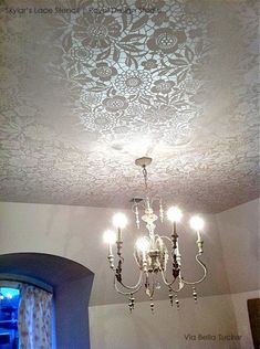 a chandelier hanging from the ceiling in a room