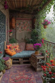 a porch with lots of flowers and plants on it