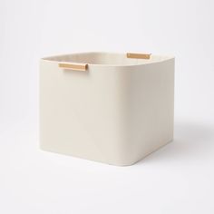 a white square container with gold handles