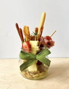 a glass jar filled with food on top of a wooden table