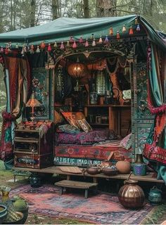 an outdoor bed with curtains and pillows on the top is made out of old furniture