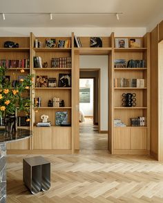 a living room filled with lots of wooden bookshelves