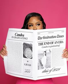 a woman in pink holding up a newspaper