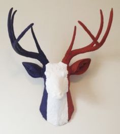 a deer head with red, white and blue antlers on it's back