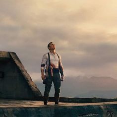 a man standing on top of a cement ramp