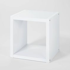 an empty white cube on a plain surface