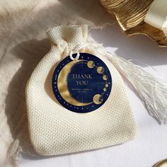 a thank you bag with the moon and stars on it sitting next to other items