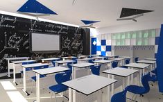 an empty classroom with blue and white desks