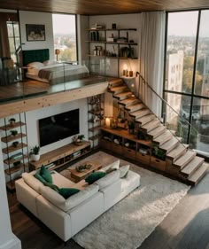 a living room filled with furniture and a fire place in front of a large window