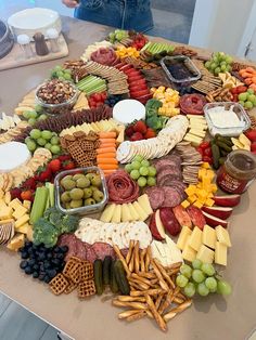 a table topped with lots of different types of cheeses and crackers on top of it