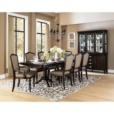 a dining room table with chairs and a china cabinet