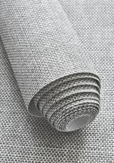 a roll of gray fabric on top of a table