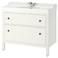 a white bathroom vanity with two drawers and a faucet on the sink side