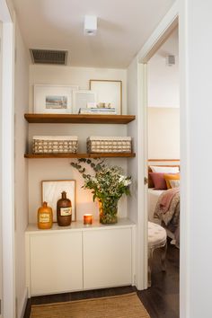 a room with some shelves and flowers on it