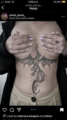 a woman with tattoos on her stomach and hands covering her face while holding her chest