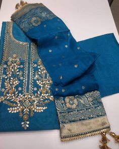 Item Overview ATHARVA Hand Embroidered Salwar Kameez inNavy Blue w/Embroidered Neck/Banarsi Silk Dupatta/Gota Patti/Custom Stitching/Wedding/Latkans/CH Dno. CH Fabric: * Shirt: Chanderi Silk - Navy Blue - 2.5 Mts, with Beautiful Embroidery Neck * Dupatta: Banarsi Silk Dupatta. (Motifs may wary) * Salwar: Santoon Silk - 2.5 Mts. Excusive Hand Embroidered Party Wear Punjabi Suit. Customization: * Fabrics: Designs Can be made in different Fabrics. * Stitching Available Care: * Dry Clean/ Avoid dire Embroidered Suits, Embroidered Salwar, Indian Salwar Kameez, Embroidery Neck Designs, Embroidery Suits Design, Embroidery Suits, Designs For Dresses, Silk Dupatta, Beautiful Embroidery