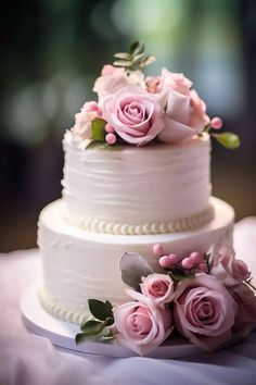 a three tiered cake with pink flowers on top