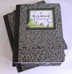 two black notebooks sitting on top of each other