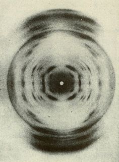 a black and white photo of a circular object in the middle of it's image