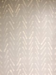 a wall with white paint on it that looks like chevron lines in the background