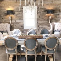 a dining room table with chairs around it and a chandelier hanging from the ceiling