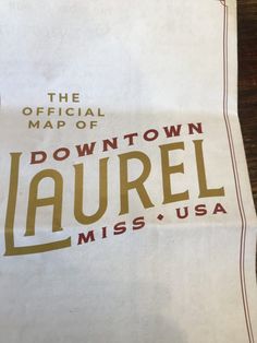 the official map of downtown laurel, miss usa on a piece of white paper with brown lettering