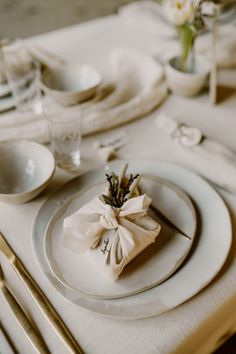 a table set with place settings and napkins