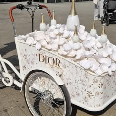 a white cart filled with lots of flowers