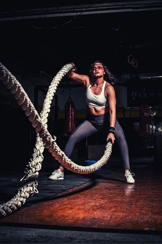 a woman is doing exercises with a rope