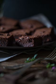 chocolate brownies on a plate with a fork