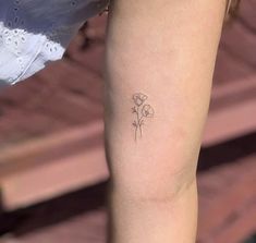 a small flower tattoo on the right thigh and lower leg, is shown in black ink