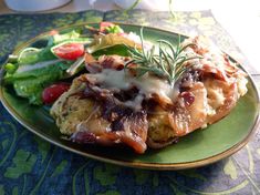 a green plate topped with meat and vegetables