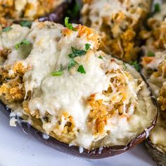 an eggplant stuffed with cheese and parmesan bread on a white plate