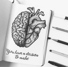 an open notebook with a drawing of a human heart and the words you have a decision to make