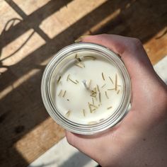 a person holding a jar with some kind of substance in it's palm hand