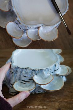 a person holding a paintbrush in front of a white bowl with ruffled edges