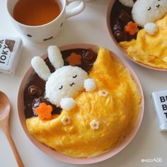 two plates filled with food next to a cup of tea