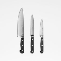 three knives with black handles on white background