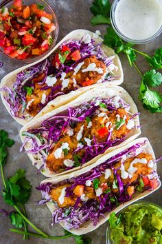 chicken tacos with coleslaw, salsa and cilantro on the side