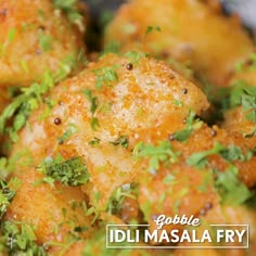 a close up view of some food with parsley on top and the words bubble idlim masala fry