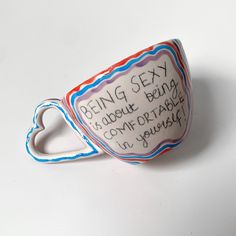 a ceramic cup with writing on it