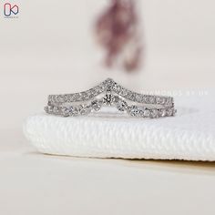 a diamond ring sitting on top of a white napkin