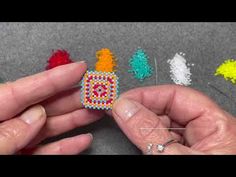 someone is making beaded earrings out of beads