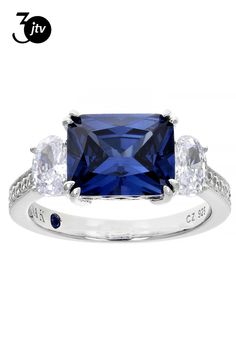 a blue sapphire and white topazte ring with three diamonds on the band, set in