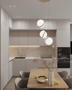 a modern kitchen and dining area with white cabinets, wood table and gray chairs in the center