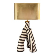 a black and white striped object with a gold square light on it's end